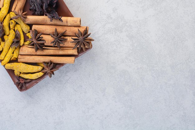 Variety of spices and herbs isolated on concrete background. 