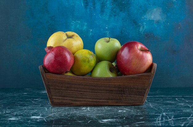 Variety of tasty fruits in wooden box. 