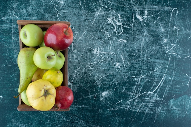 Variety of tasty fruits in wooden box