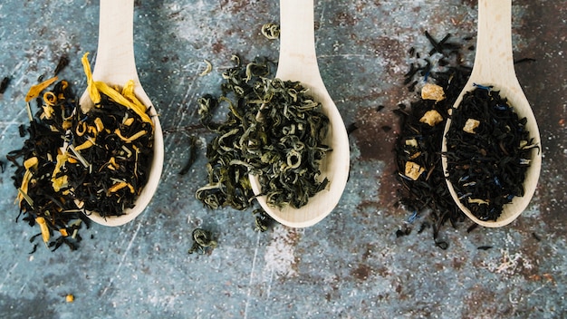 Variety of tea herbs in spoons flat lay