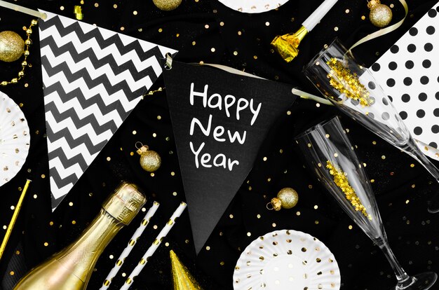 Free photo various accessories and glasses on black background and happy new year garland