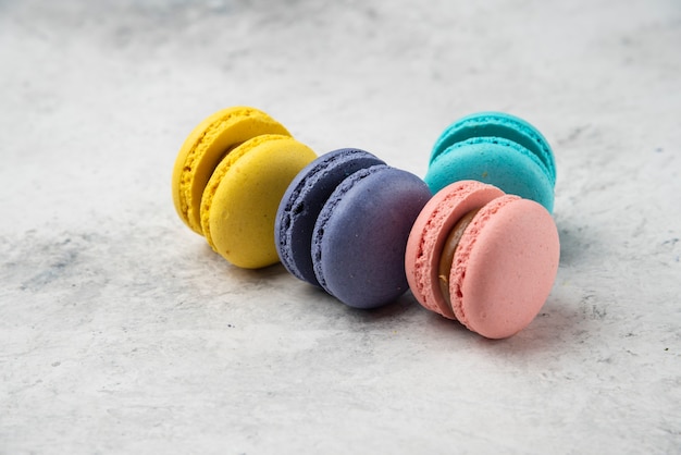 Various almond macarons on white background. . 