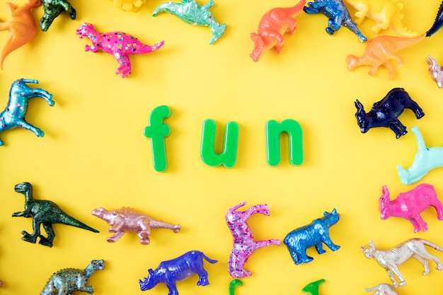 Various animal toy figures background with the word fun