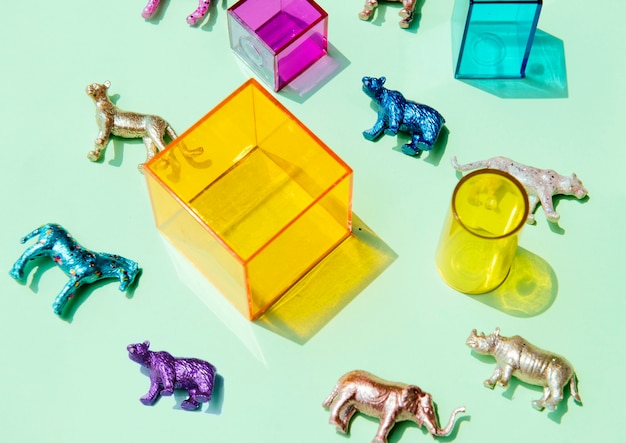 Free photo various animal toy figures with boxes and in a colorful background