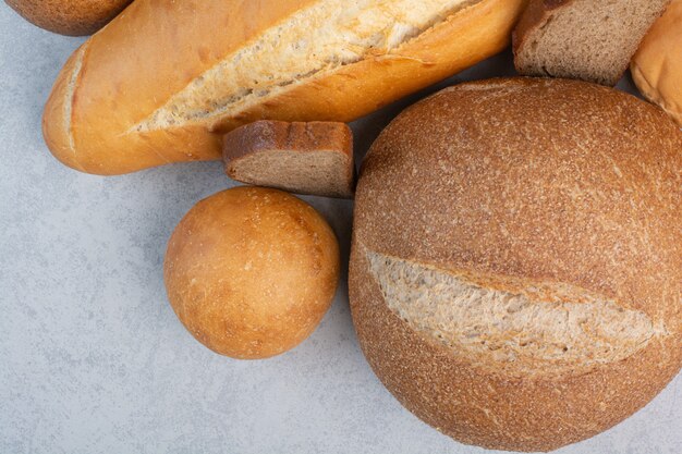 Various bread and buns on marble background. High quality photo