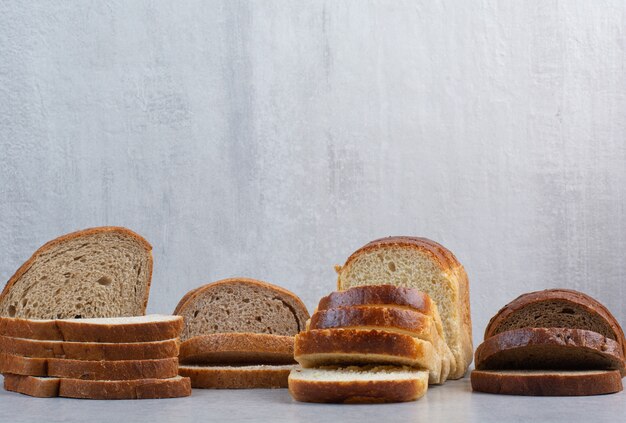 Various bread slices on marble background. High quality photo