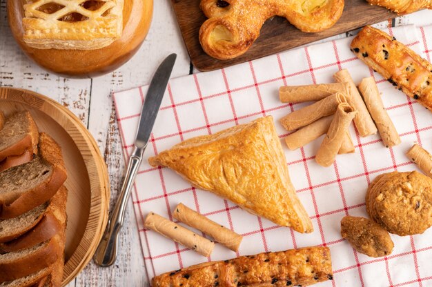 Various breads on red white cloth.