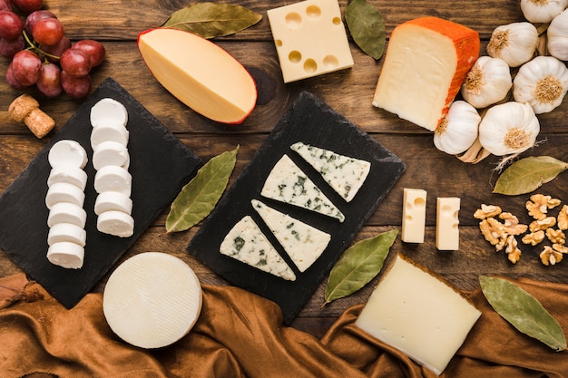 Various cheese and ingredient on wooden desk