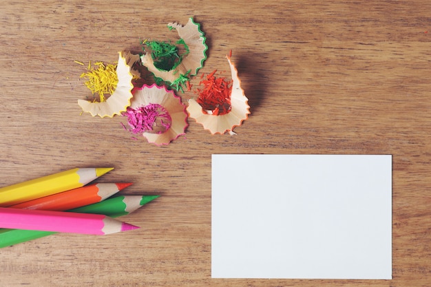 Various colored pencils on wooden table.