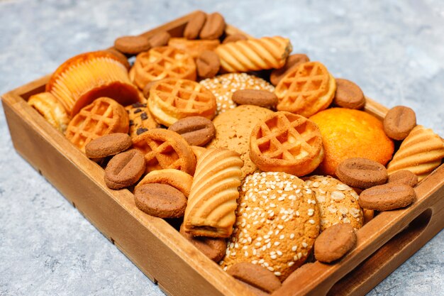 Various cookies in a wooden tray