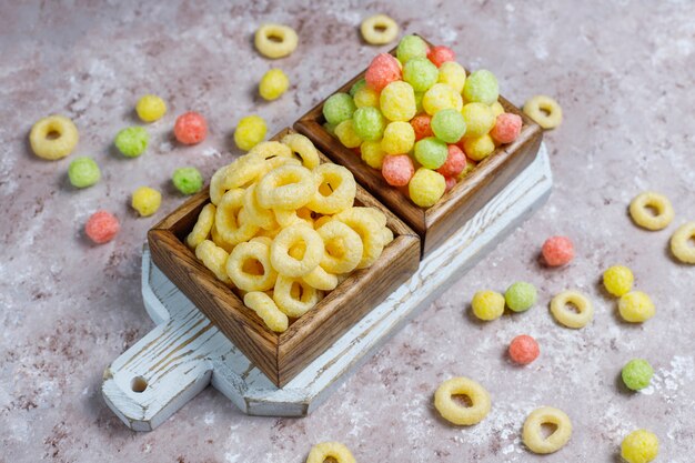 Various corn flakes in wooden boxes on concrete surface