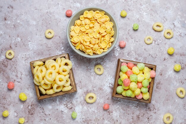 Various corn flakes in wooden boxes on concrete surface