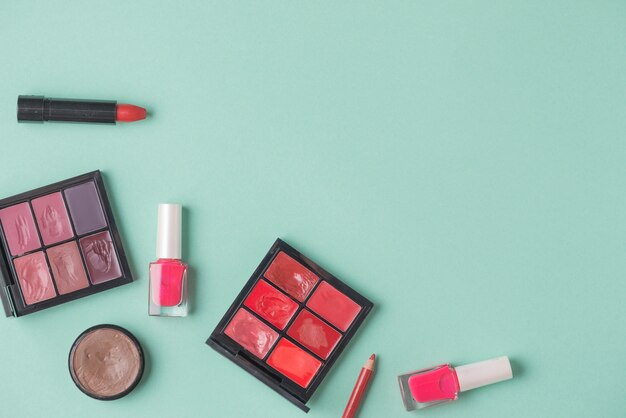 Various cosmetic product on green backdrop