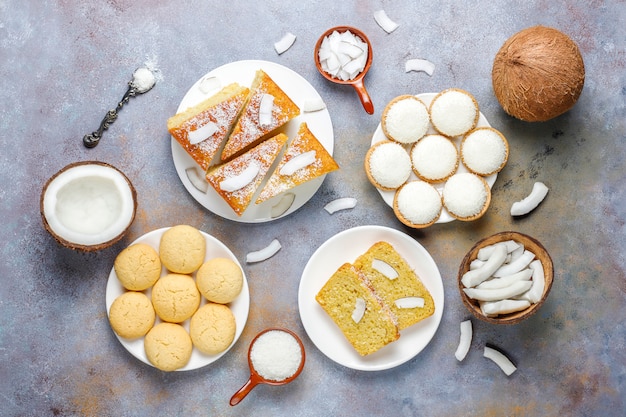 Various delicious coconut sweets,cookies,cake,marshmallow,coconut flakes and half coconut,top view