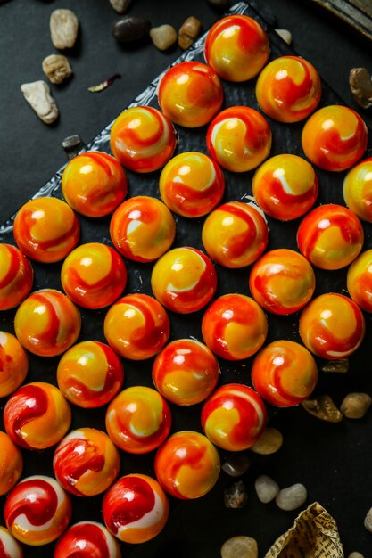 Various dessert balls topped with jam side view