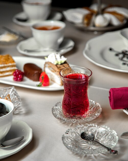 Various dessert selection and a glass of tea