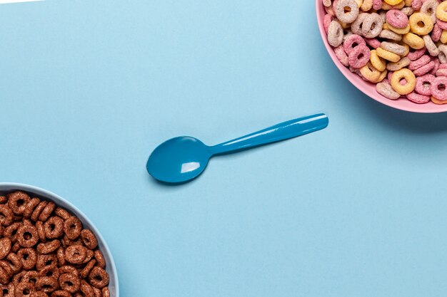 Various flavours of cereal loops fruit and chocolate with spoon