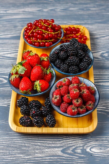 Various fresh summer berries, blueberries, red currant, strawberries, blackberries, top view.