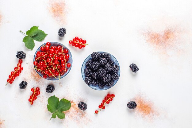 Various fresh summer berries, red currant, blackberries, top view.