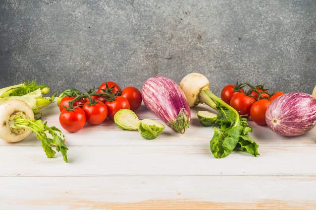 Various fresh vegetables arranged on wooden tabletop