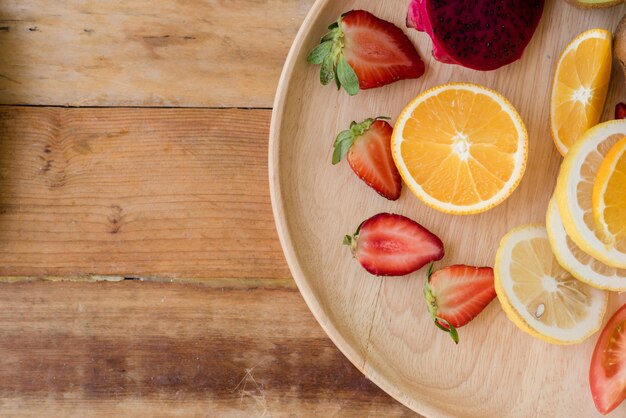 Various fruits with vegetable on wood background