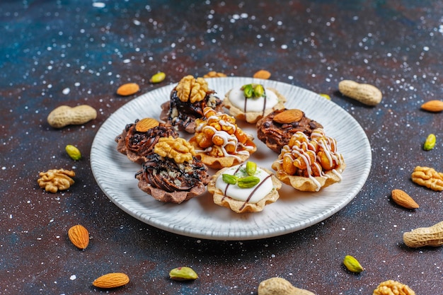Бесплатное фото Различные домашние мини-тарталетки с орехами и шоколадным кремом.