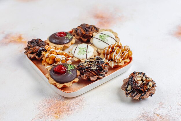 Various homemade mini tartlets with nuts and chocolate cream.