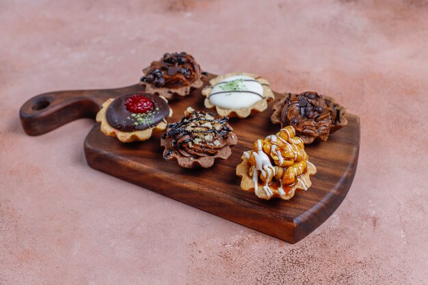 Various homemade mini tartlets with nuts and chocolate cream.