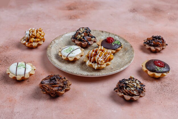 Various homemade mini tartlets with nuts and chocolate cream.