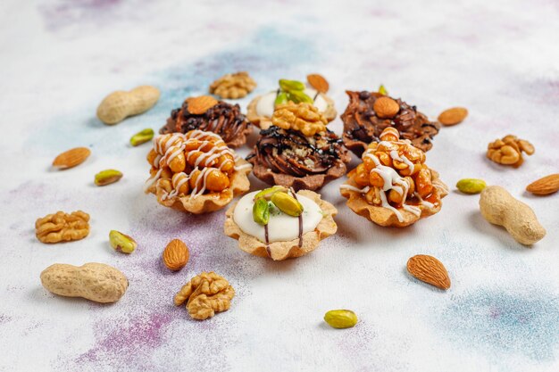 Various homemade mini tartlets with nuts and chocolate cream.