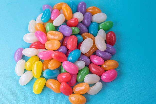 Various jelly beans on the blue background