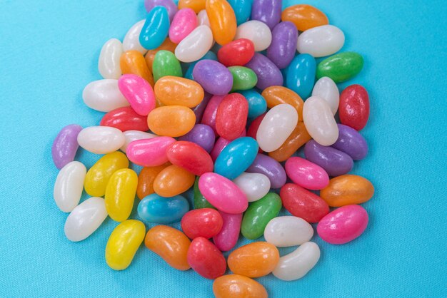 Various jelly beans on the blue background