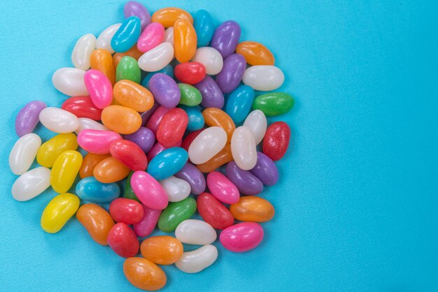 Various jelly beans on the blue background