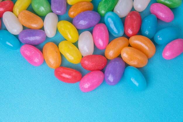 Various jelly beans on the blue background