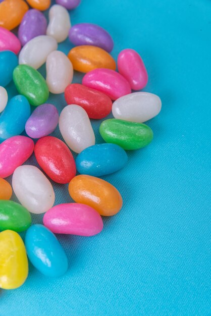 Various jelly beans on the blue background