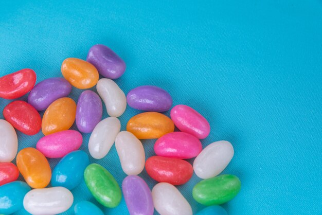 Various jelly beans on the blue background