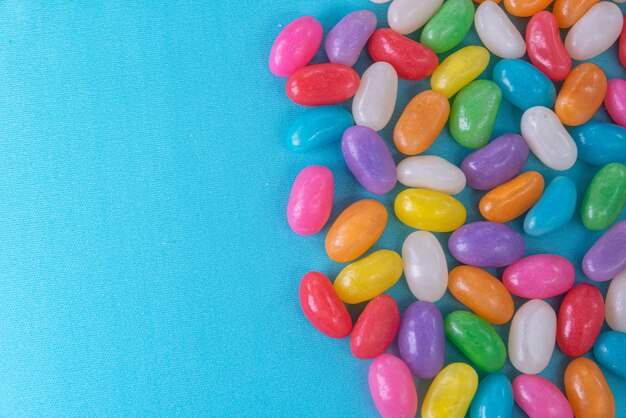 Various jelly beans on the blue background