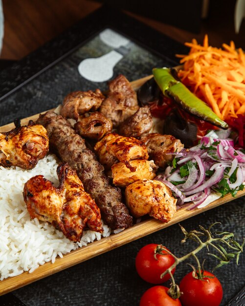 Various kebab with rice and vegetables
