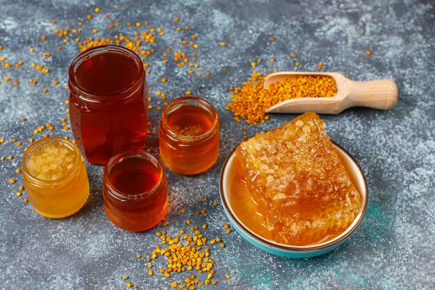 Various kinds of honey in glass jars,honeycomb and pollen