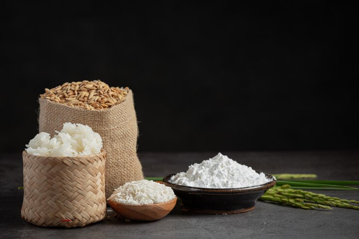 मुफ़्त फोटो various kinds of produce from rice on dark floor