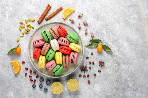 Various macaroons with pistachios,fruits,berries,coffee beans.