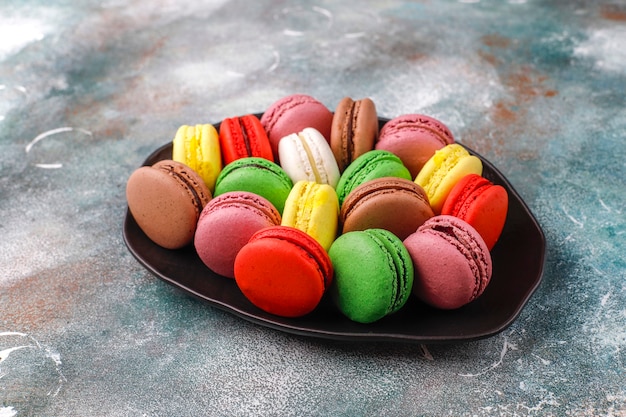 Various macaroons with pistachios,fruits,berries,coffee beans.