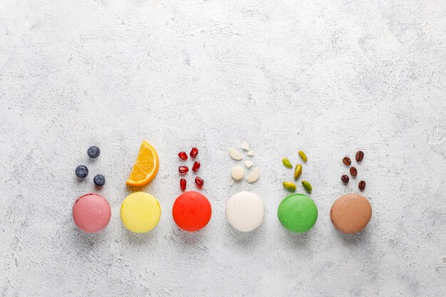 Various macaroons with pistachios,fruits,berries,coffee beans.