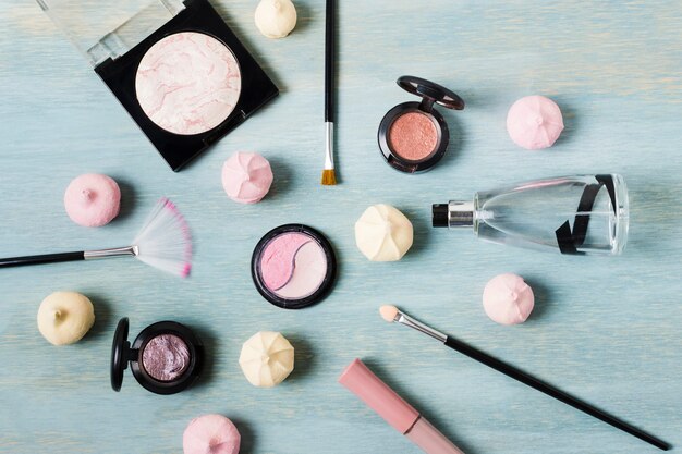 Various makeup products next to sweets