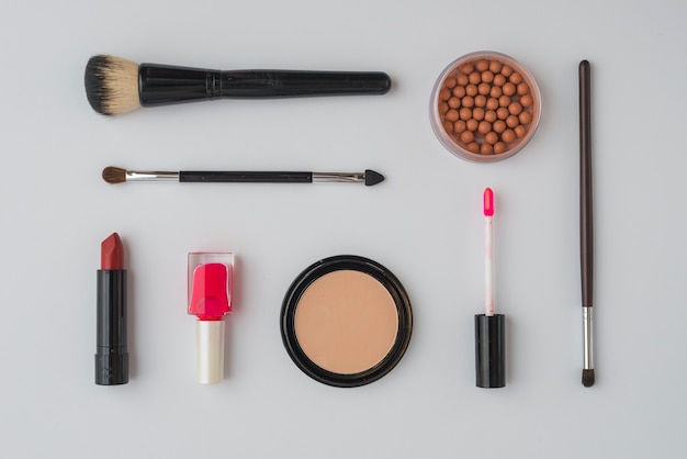 Various makeup products on white background