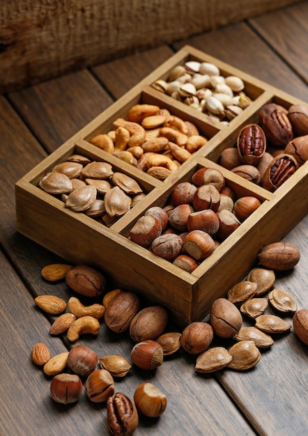 Free photo various nuts in wooden box