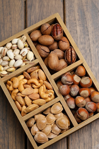 Free photo various nuts in wooden box