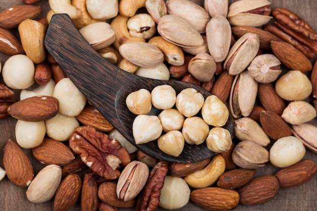 Various organic nuts snack and spoon background