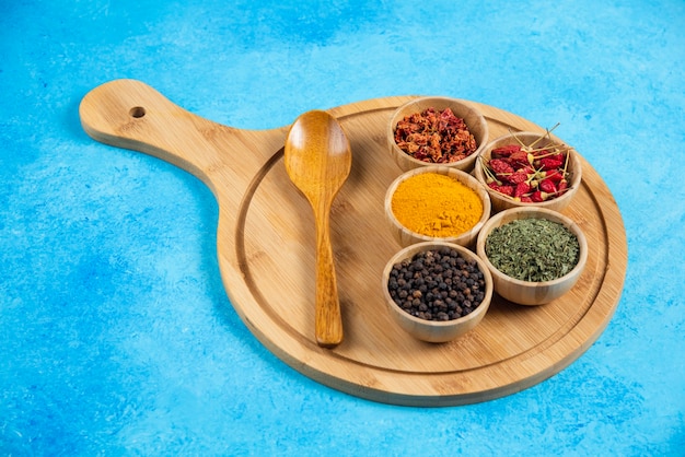 Various organic spices on wooden board.