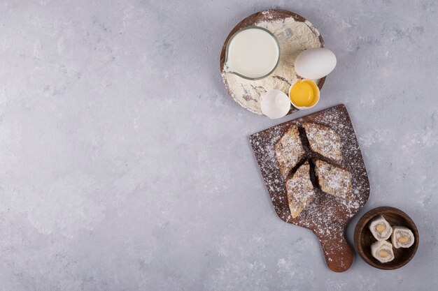 Various pastries and ingredients on the wooden platter